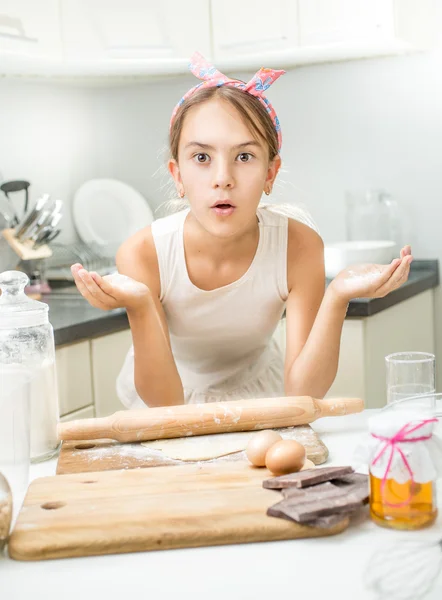 Portrait of funny cute girl making dough on kitchen — Stock Photo, Image