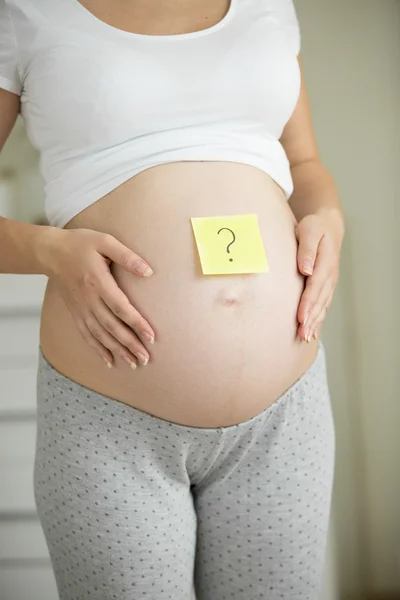 Soru işareti post it etiket üzerinde çizilmiş hamile closeup — Stok fotoğraf
