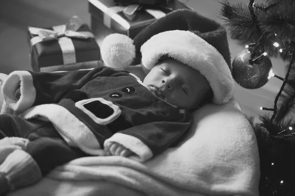 Monochrome portrait of sleeping baby boy in Santa costume — Stock Photo, Image