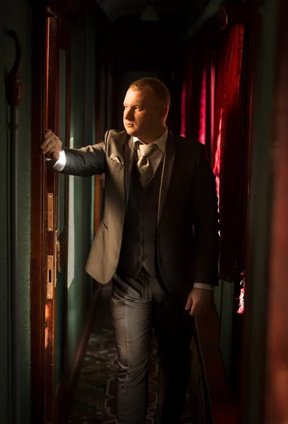 Toned portrait of man in suit at steam train — Stock Photo, Image