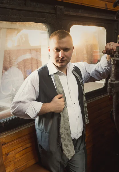 Confident businessman posing in retro train — Stock Photo, Image