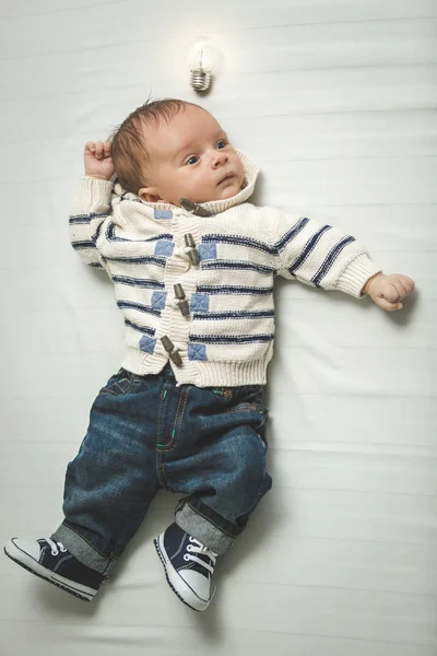 Conceptual portrait of smart baby boy with glowing light bulb ov — Stock Photo, Image