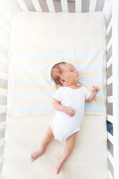 Cute baby lying in white cradle at sunny day — Stock Photo, Image