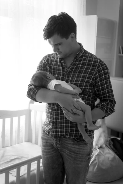 Black and white portrait of happy father holding little baby — Stock Photo, Image