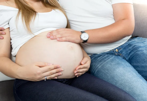 Expectant father touching big wife's belly — Stock Photo, Image