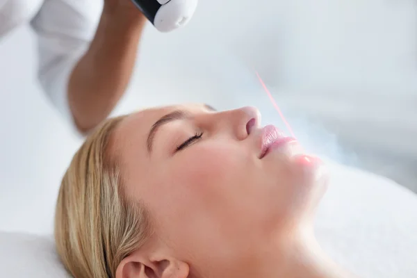 Young woman receiving local cryotherapy on her face — Stock Photo, Image