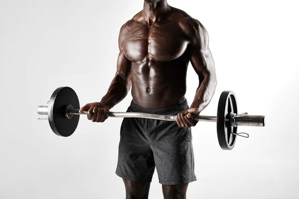 Muscular african male exercising with barbell — Stock Photo, Image