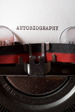 Autobiography word written with a typewriter. clipart