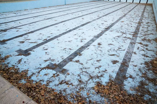 View of an empty and dirty swimming pool.