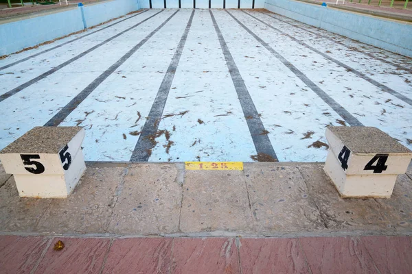 View of an empty and dirty swimming pool.