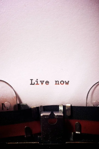 Live now phrase written with a typewriter.