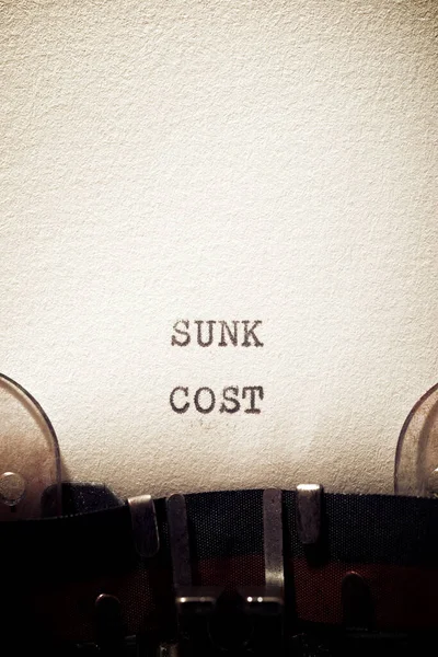 Sunk cost phrase written with a typewriter.
