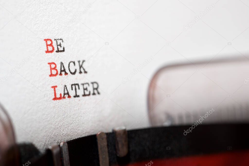 Be back later phrase written with a typewriter.