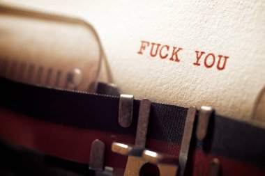 Fuck you text written with a typewriter.
