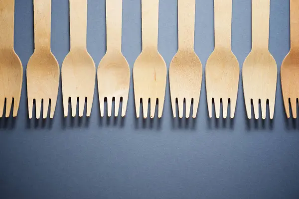 Disposable wooden cutlery on a table.