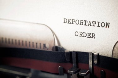 Deportation order phrase written with a typewriter. clipart