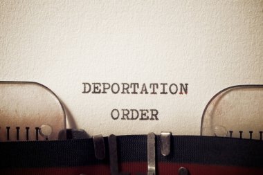 Deportation order phrase written with a typewriter. clipart