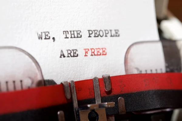 We, the people are free phrase written with a typewriter.