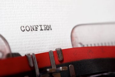 The word confirm written with a typewriter.