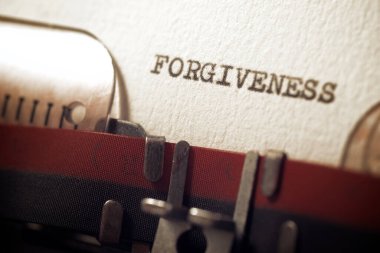 The word forgiveness written with a typewriter.