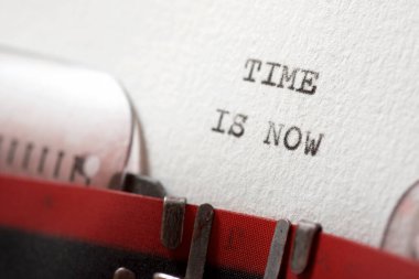 Time is now phrase written with a typewriter.