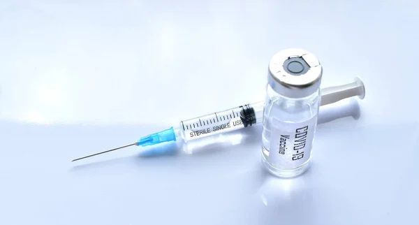 Vaccine against covid-19 and a syringe with a vaccine. Isolate