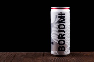 Minsk. Beyaz Rusya. 24 Ekim 2020 Stüdyo Işıklandırma. Eski bir taşın ahşap arka planında üzerinde su damlaları olan metal bir kutu var. Siyah arka plan. borjomi.