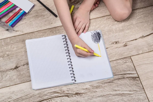 Iluminación Niño Sostiene Lápiz Mano Dibuja Cuaderno Situado Suelo Primer — Foto de Stock