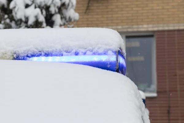 daylight. police siren blue under the snow. Close-up
