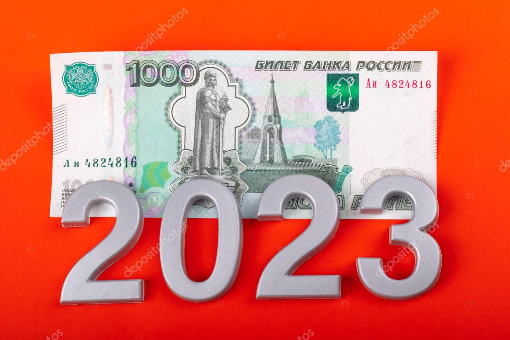 close-up. Black background. on it are numbers 2023 and a bill of 1000 rubles. Russia