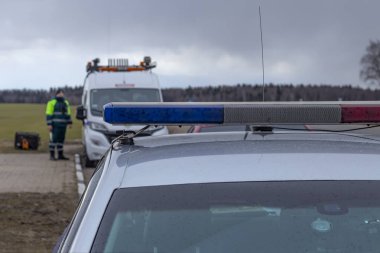Sokak lambası. Özel bir araba. Üzerinde mavi ya da kırmızı yanıp sönen ışıklar var. Yumuşak odak
