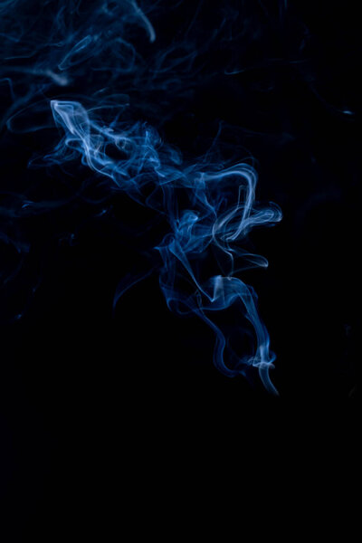 Black background, blue smoke coming out, close-up.