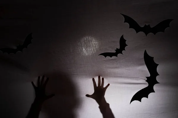 halloween. a shadow or silhouette of two hands, with a white cloth. in transparency with space to copy your text.