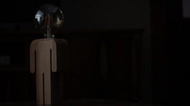 Round Light Bulb with a Wooden Structure. Close-Up. 