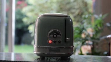 Man taking out Toasts from a Retro Toaster. Close Up.