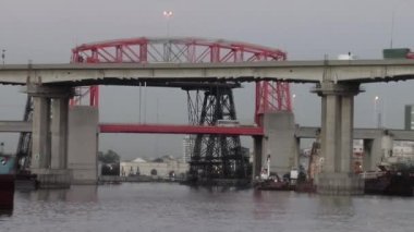 Arjantin, Buenos Aires 'teki Eski Taşıyıcı Köprüsü ve Güney Otoyolu, Şafakta Limandan ayrılan bir römorkörden görüldüğü gibi..  