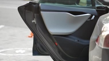 Elektrikli araba sokakta batarya çalıştırıyor. Şarj kablosu takıldı