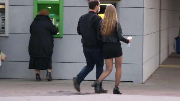 Unrecognizable couple is walking down street. Girl and guy are walking together — Stock Video