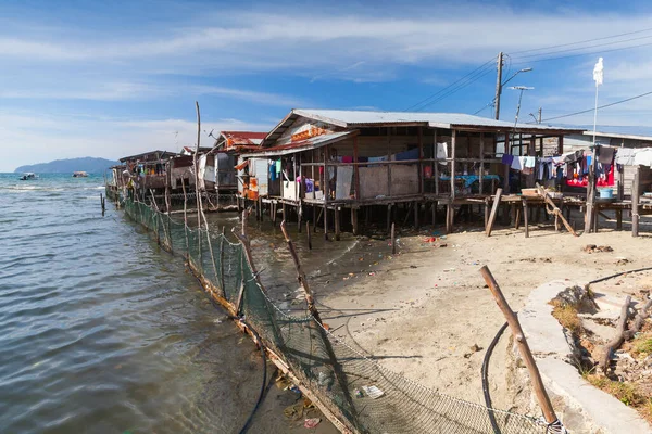 Wooden houses and footbridges on stilts. Poor coastal district of Kota Kinabalu, Malaysia — Stock Image Wooden Houses Footbridges Stilts Poor Coastal District Kota Kinabalu Malaysia Royalty Free Stock Images