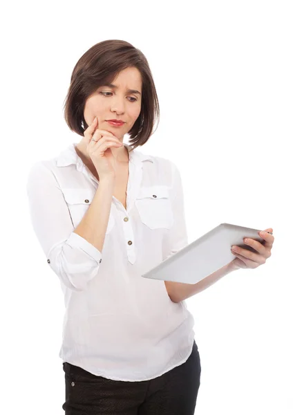 Mujer sosteniendo una tableta electrónica y mirando dudoso —  Fotos de Stock