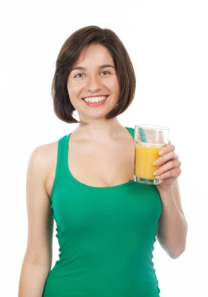 Smiling brunette drinking an orange juice — Stock Photo, Image