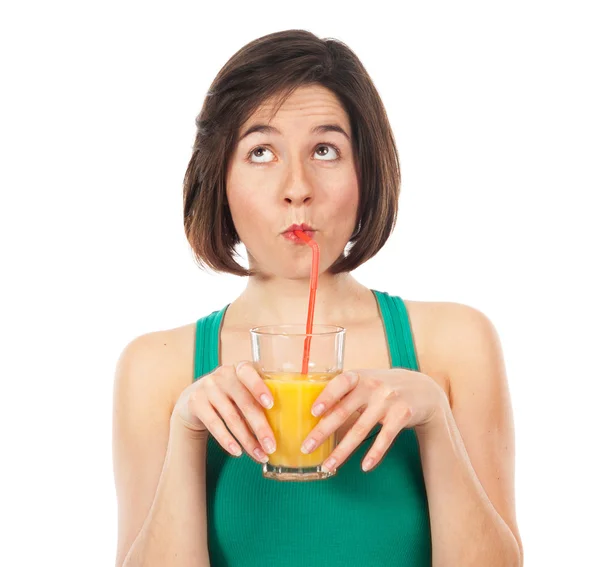 Funny brunette drinking an orange juice — Stock Photo, Image