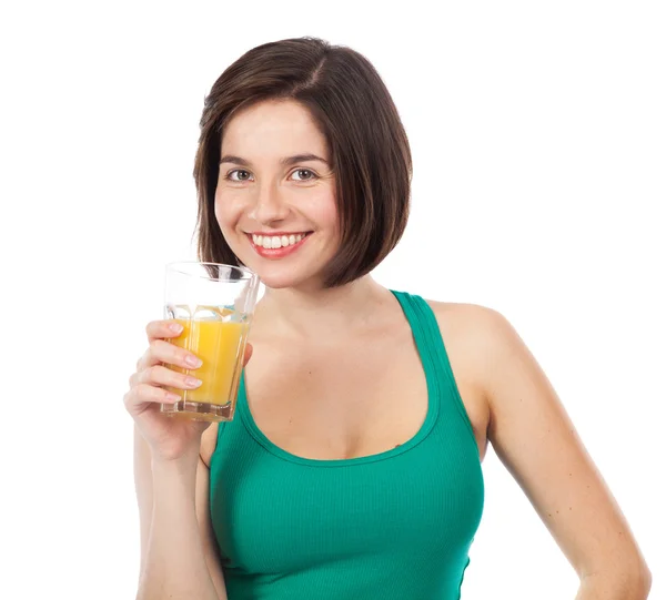 Cute smiling brunette drinking an orange juice — Stock Photo, Image
