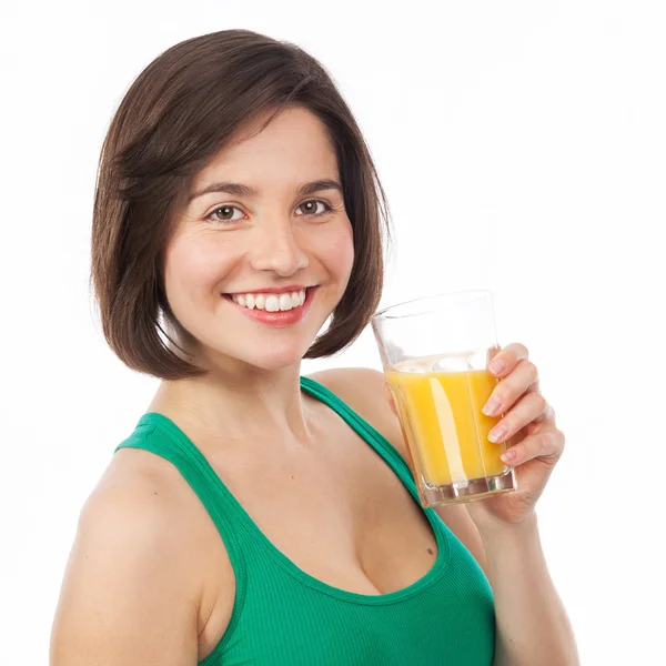 Smiling young woman drinking an orange juice — Stock Photo, Image