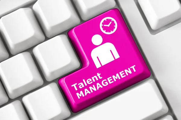 keyboard with a talent management button, an internet symbol, the silhouette of a man and the inscription talent management on a computer button