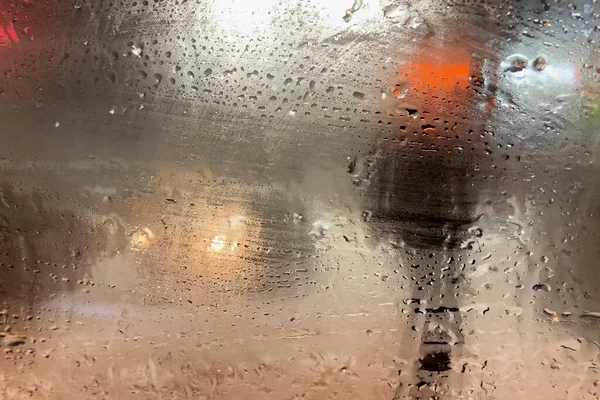 rain on the road from car window, dangerous vehicle driving in rainy. Abstract blurred bad weather car