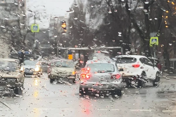 rain on the road from car window, dangerous vehicle driving in rainy. Abstract blurred bad weather car