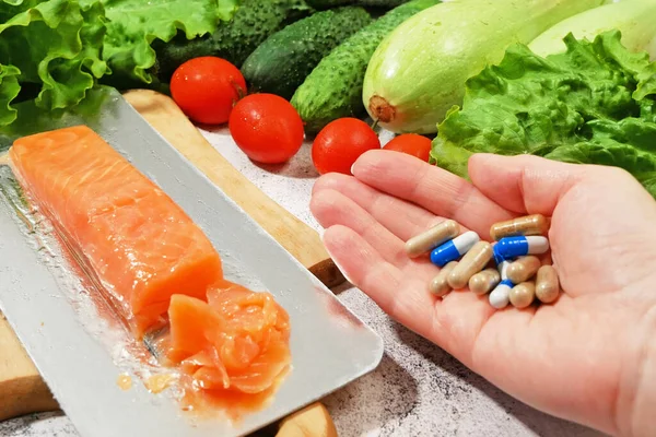 Healthy food vs pills. Salmon, vegetables and fruis vs medicine and drugs. Closeup