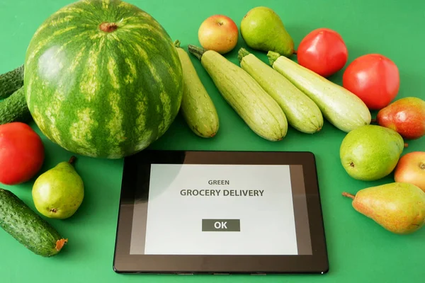 Organic Vegetables and fruits in cotton bag and tablet pc, online market, green grocery delivery at home concept, buy online  concept