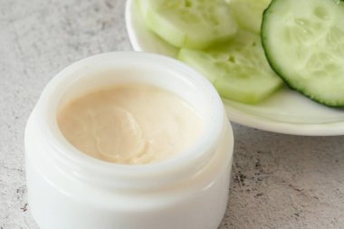 Salatalık kozmetik krem yüz ve gümüş arka planda el, cilt ve vücut bakımı hijyen losyonu, yakın çekim